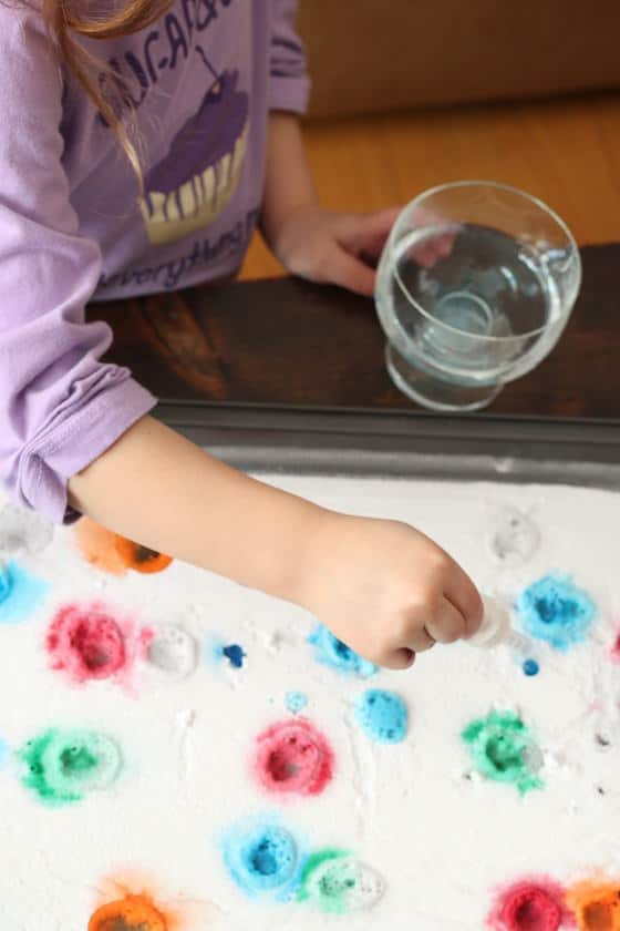 cild dripping vinegar on baking soda