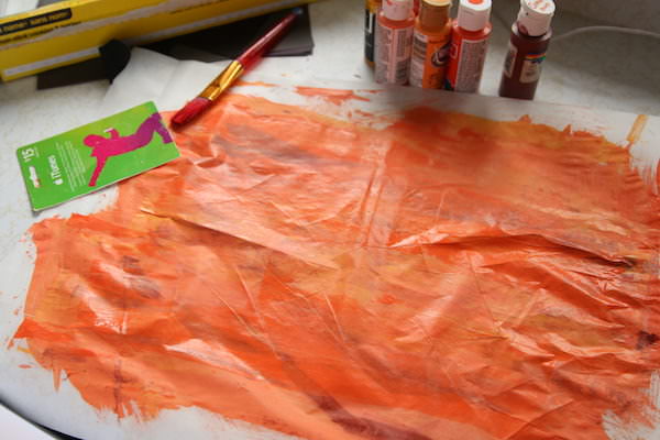 orange paint on wax paper
