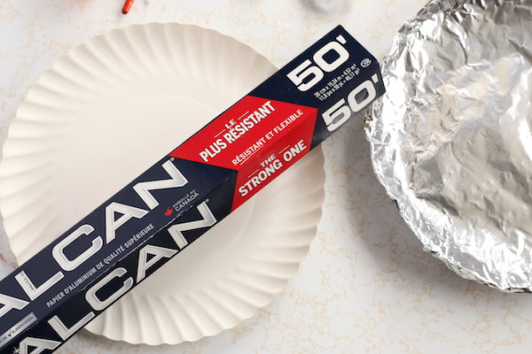 tin foil wrapped paper plate beside roll of tin foil